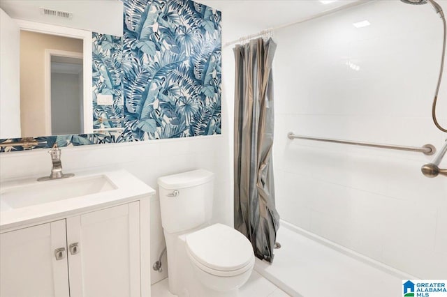 bathroom featuring curtained shower, vanity, tile walls, and toilet