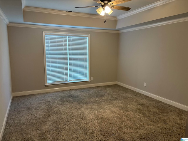 carpeted spare room with a raised ceiling, crown molding, and ceiling fan