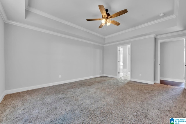 spare room featuring carpet flooring, a tray ceiling, ceiling fan, and crown molding