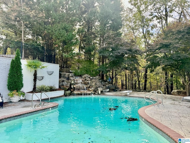 view of pool featuring a diving board and a patio