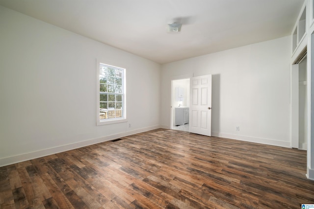 unfurnished bedroom with dark wood-type flooring