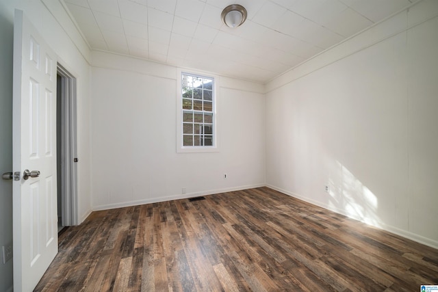 empty room featuring dark hardwood / wood-style flooring