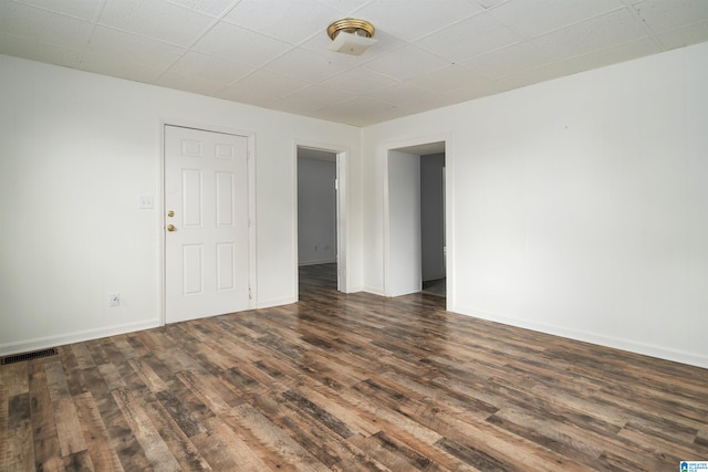 unfurnished room featuring dark hardwood / wood-style flooring