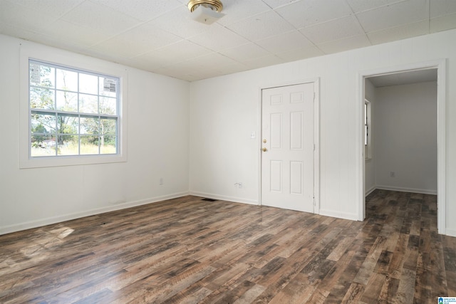 empty room with dark wood-type flooring