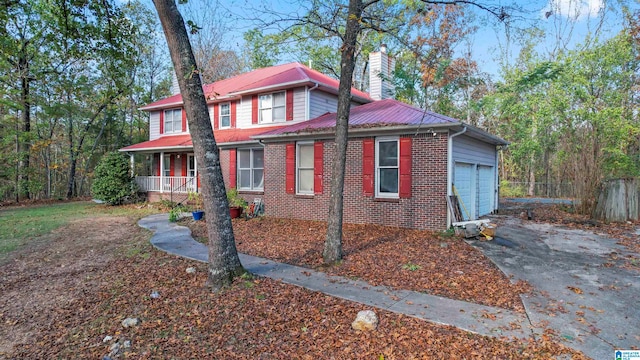 view of front facade featuring a porch and a garage