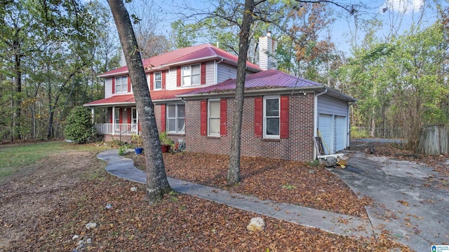 130 Big Oak Dr, Maylene, AL 35114 - view of front facade with a garage, a chimney, a porch, brick siding, and driveway