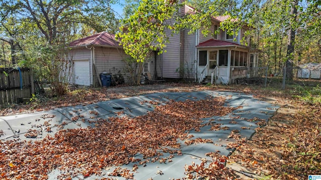 view of front of property with a sunroom and a garage