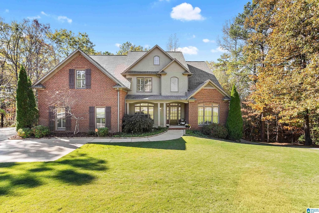 908 Timberline Cir, Calera, AL 35040 - view of front of property with a front lawn, brick siding, and roof with shingles