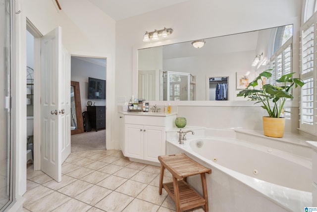 bathroom featuring tile patterned flooring, vanity, and separate shower and tub