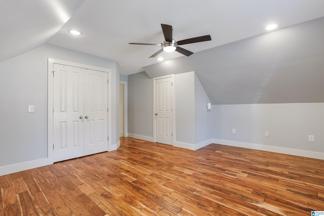 additional living space with ceiling fan, vaulted ceiling, and light hardwood / wood-style flooring