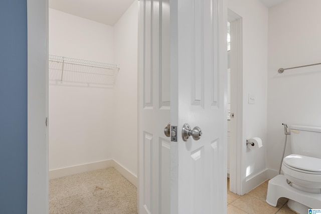 bathroom featuring tile patterned floors and toilet