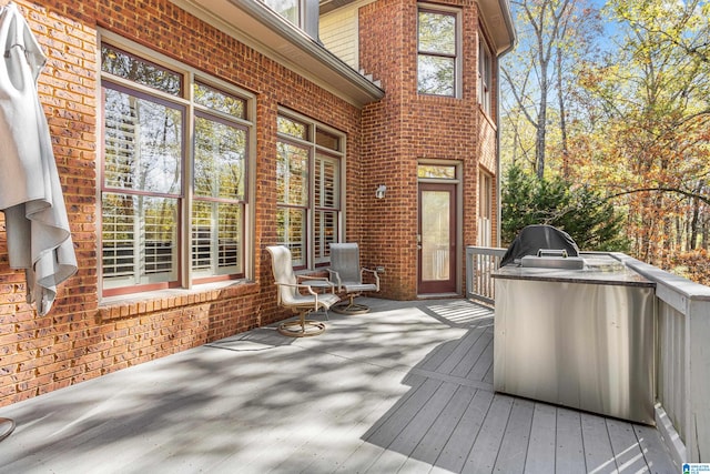 wooden deck featuring a grill