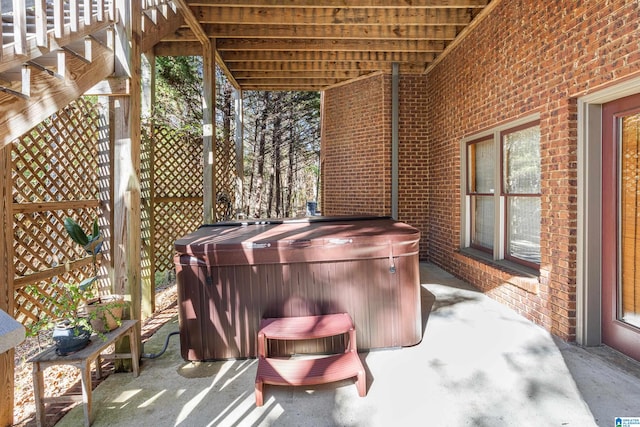 view of patio / terrace with a hot tub