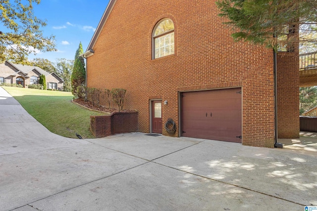 view of side of home featuring a lawn and a garage