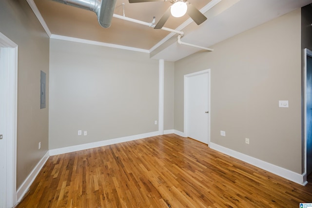 unfurnished bedroom featuring ceiling fan, wood-type flooring, ornamental molding, and electric panel