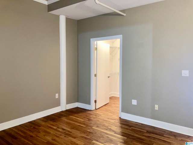 unfurnished room featuring crown molding and hardwood / wood-style floors