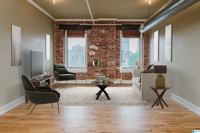 2416 1st Ave Unit 10, Birmingham, AL 35203 - sitting room featuring wood finished floors, brick wall, and baseboards
