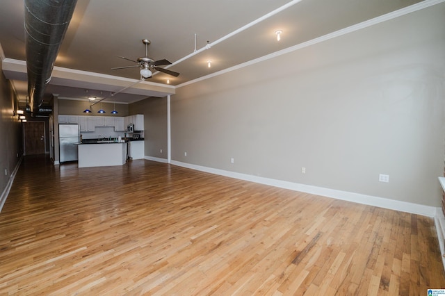 2416 1st Ave Unit 10, Birmingham, AL 35203 - unfurnished living room featuring a ceiling fan, wood finished floors, baseboards, and ornamental molding