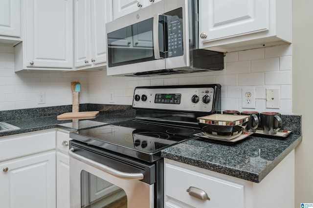 2416 1st Ave Unit 10, Birmingham, AL 35203 - kitchen featuring appliances with stainless steel finishes, white cabinetry, dark countertops, and decorative backsplash