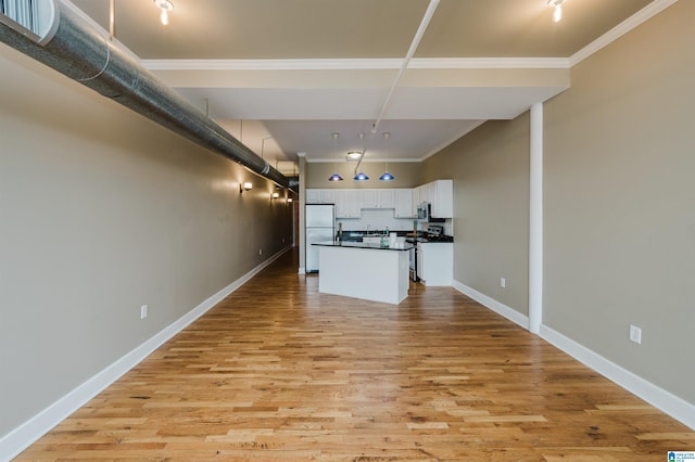 2416 1st Ave Unit 10, Birmingham, AL 35203 - kitchen featuring appliances with stainless steel finishes, dark countertops, white cabinetry, ornamental molding, and baseboards
