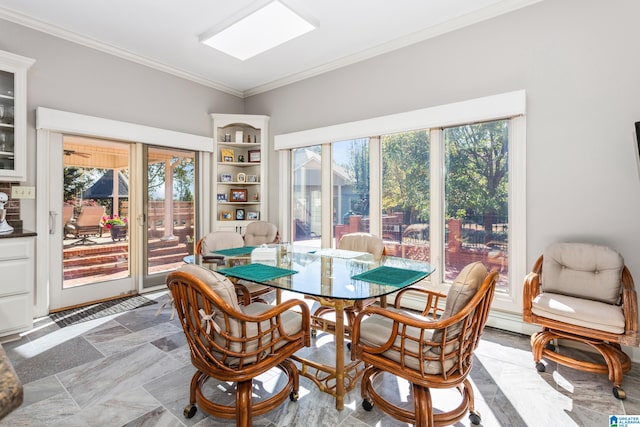 dining room featuring crown molding and plenty of natural light