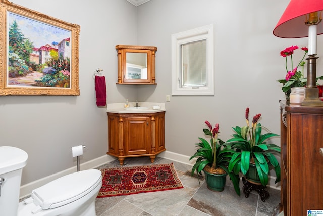 1001 Kingsway Dr, Anniston, AL 36207 - half bath featuring toilet, baseboards, vanity, and tile patterned floors