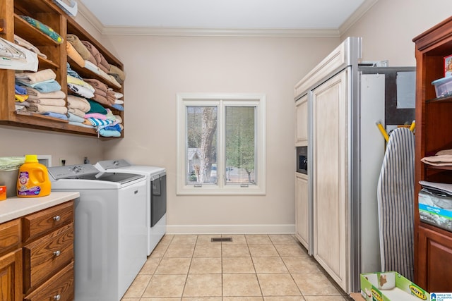 laundry area featuring light tile patterned floors, independent washer and dryer, and crown molding