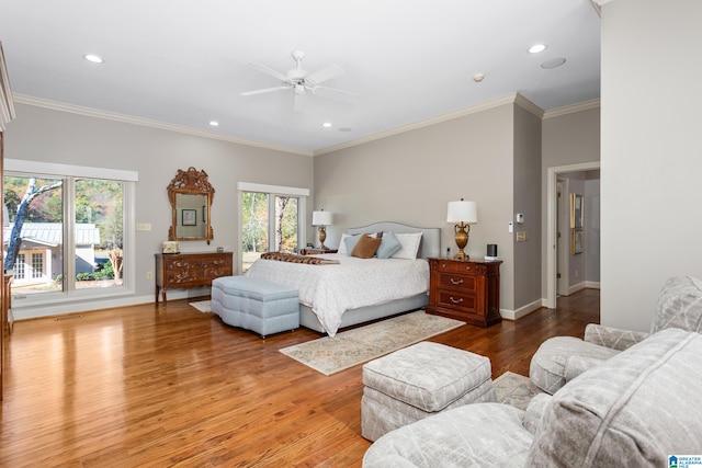 bedroom featuring hardwood / wood-style flooring, ceiling fan, and ornamental molding