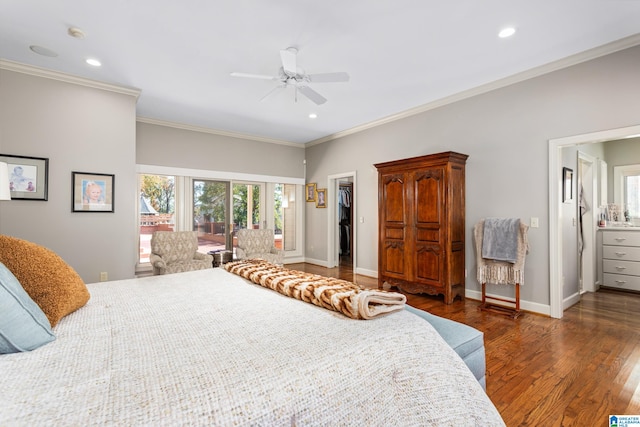 bedroom featuring connected bathroom, ceiling fan, a spacious closet, dark hardwood / wood-style floors, and ornamental molding