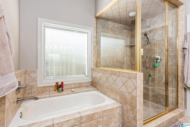 bathroom featuring shower with separate bathtub and a healthy amount of sunlight