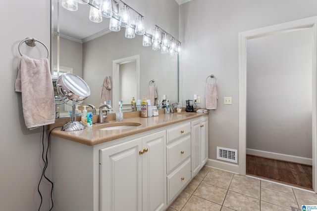 1001 Kingsway Dr, Anniston, AL 36207 - full bathroom with tile patterned floors, double vanity, crown molding, and baseboards