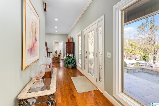 foyer entrance featuring hardwood / wood-style floors and crown molding