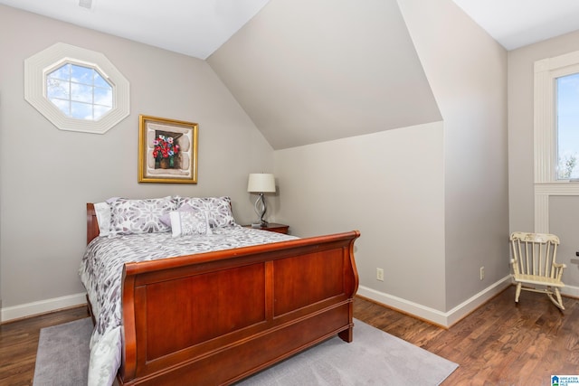 bedroom with dark hardwood / wood-style flooring and lofted ceiling