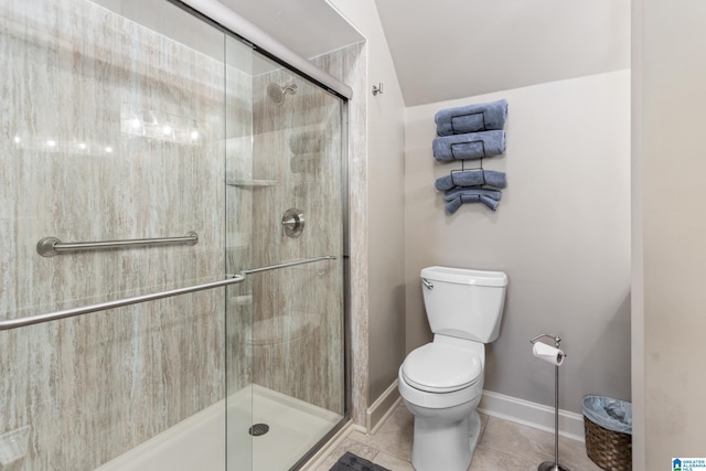 bathroom featuring tile patterned flooring, toilet, and an enclosed shower