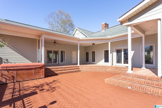 exterior space featuring a patio area, ceiling fan, and a hot tub