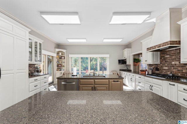 kitchen featuring a center island, white cabinetry, custom range hood, and appliances with stainless steel finishes