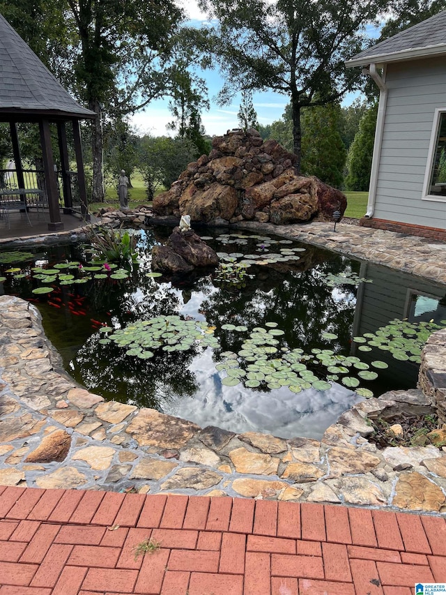 view of pool featuring a garden pond