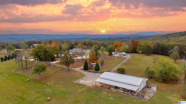 aerial view at dusk featuring a mountain view