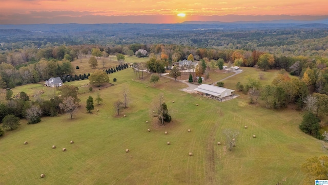 aerial view at dusk featuring a rural view