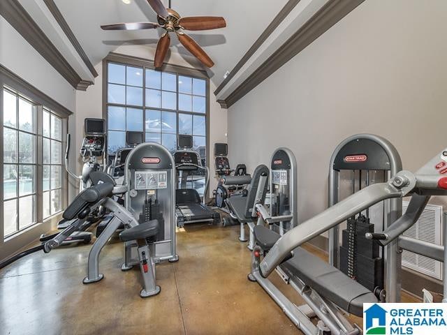 gym with ceiling fan, concrete floors, and ornamental molding