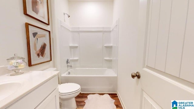 full bathroom featuring hardwood / wood-style flooring, vanity,  shower combination, and toilet