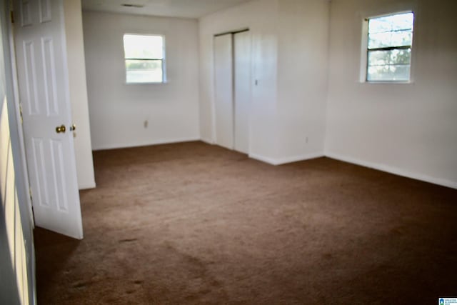 unfurnished bedroom featuring dark carpet