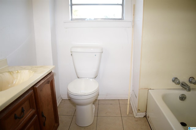 bathroom with tile patterned flooring, vanity, and toilet