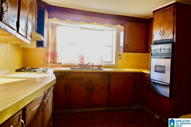 kitchen featuring stainless steel oven and sink