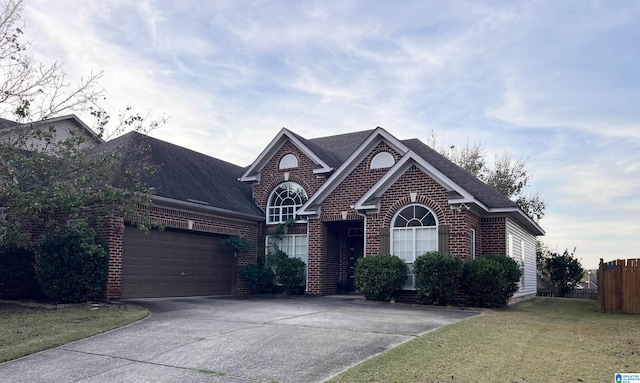 view of front of home with a garage and a front lawn