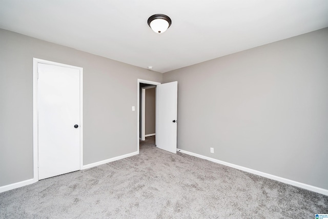 unfurnished bedroom featuring light colored carpet