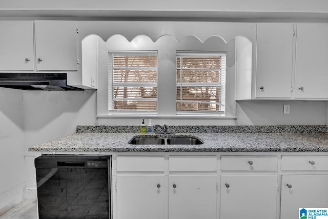 kitchen featuring light stone counters, sink, white cabinets, and black dishwasher