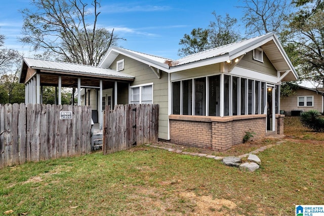 exterior space with a sunroom and a yard