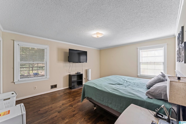 bedroom with dark wood-type flooring, a textured ceiling, and ornamental molding