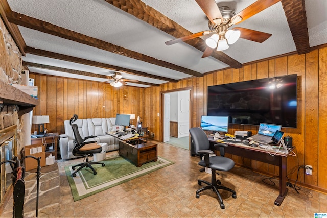 office space with beam ceiling, wooden walls, ceiling fan, and a textured ceiling